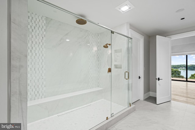 bathroom with a marble finish shower, baseboards, and marble finish floor