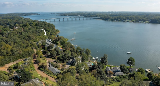 aerial view with a wooded view and a water view