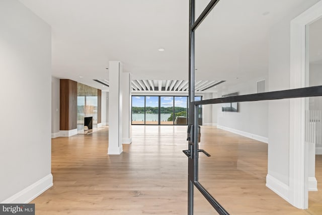 interior space with visible vents, wood finished floors, and baseboards