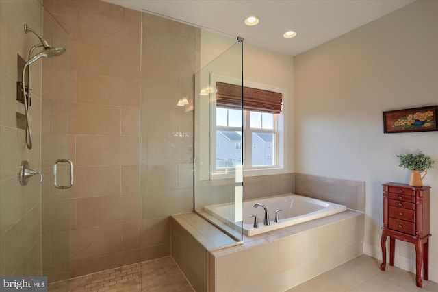 bathroom featuring tile patterned floors and separate shower and tub