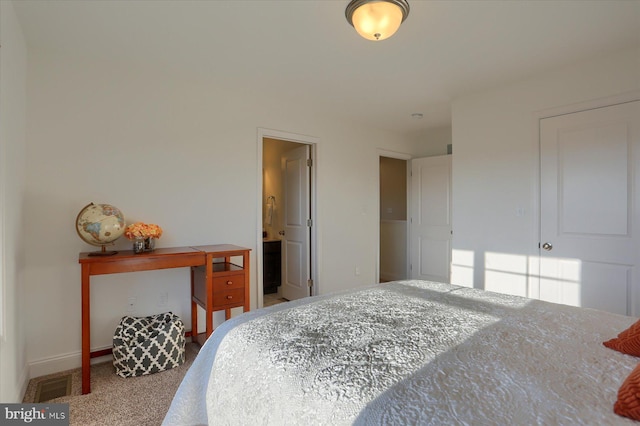 carpeted bedroom with ensuite bathroom