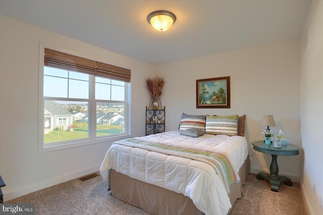 bedroom featuring light colored carpet