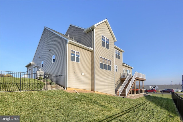 back of house with a yard and a deck