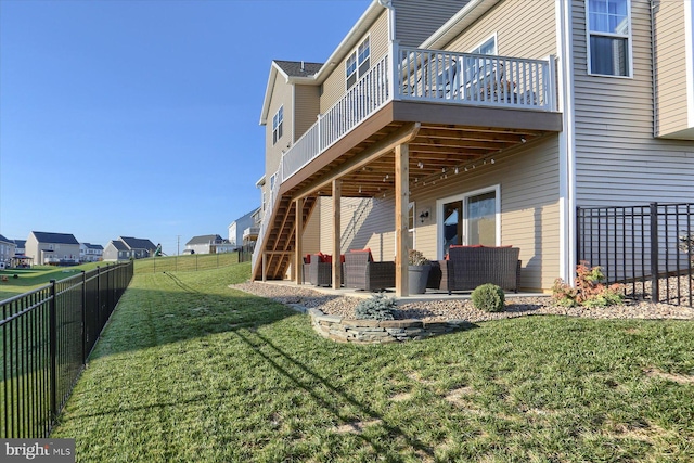 rear view of property with a patio area, a deck, and a lawn