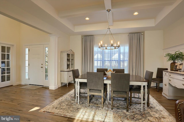 dining space with an inviting chandelier, beamed ceiling, dark wood-type flooring, and plenty of natural light