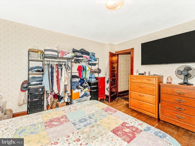 bedroom with dark hardwood / wood-style flooring