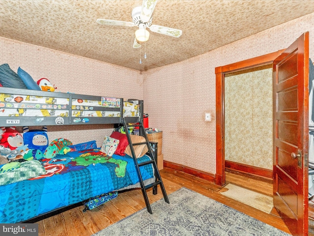 bedroom with hardwood / wood-style floors and ceiling fan