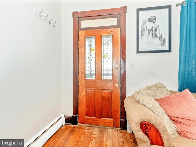 foyer with light hardwood / wood-style floors and a baseboard radiator