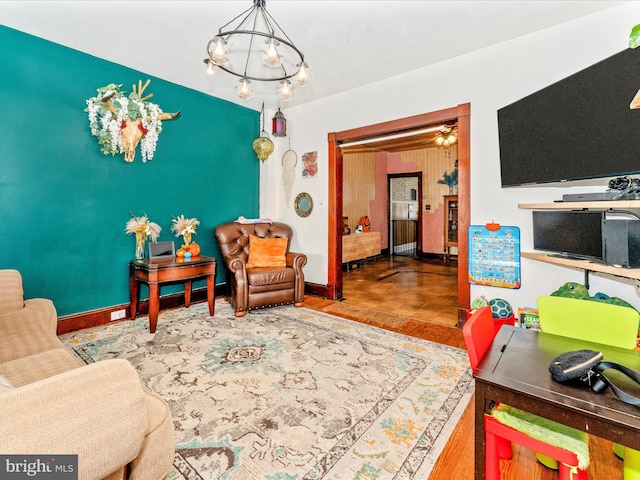 living room featuring hardwood / wood-style flooring and a chandelier