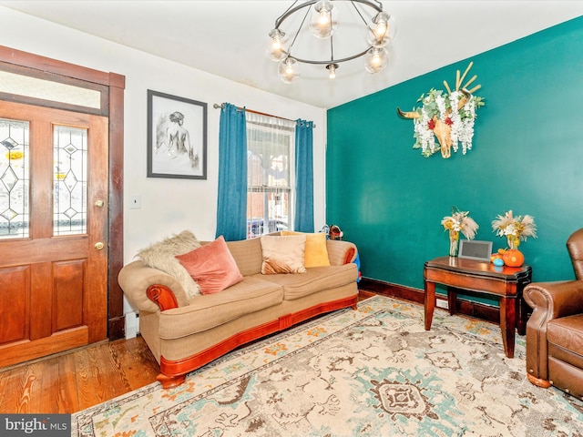 living room with hardwood / wood-style flooring and an inviting chandelier