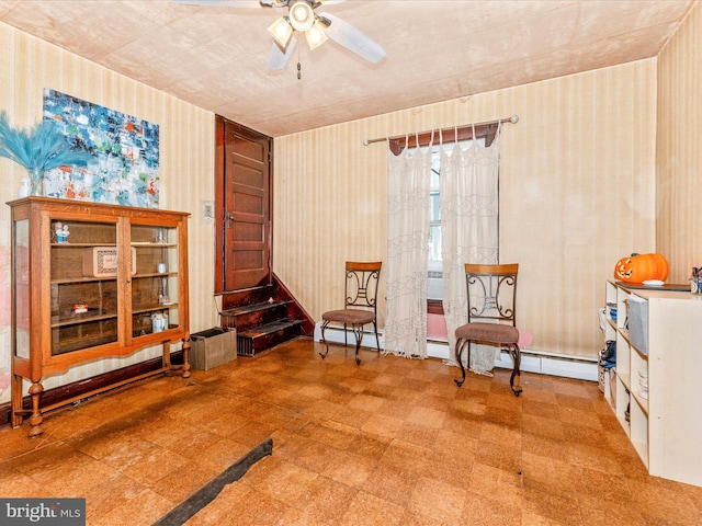 sitting room featuring ceiling fan