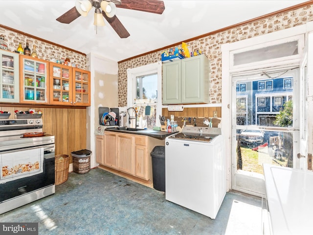 kitchen with washer / dryer, crown molding, stainless steel stove, and sink