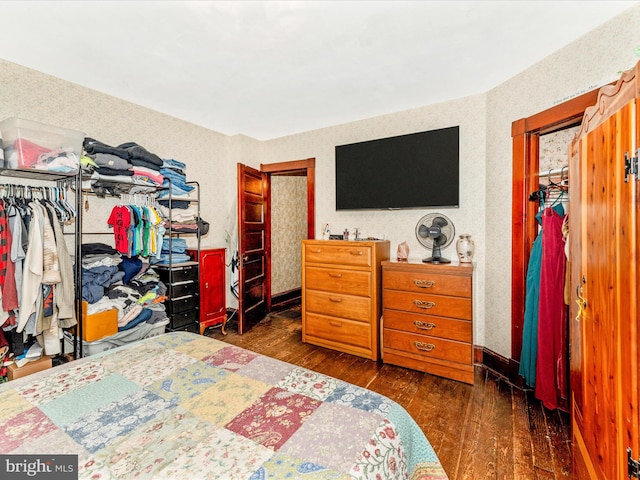 bedroom featuring a closet and dark wood-type flooring