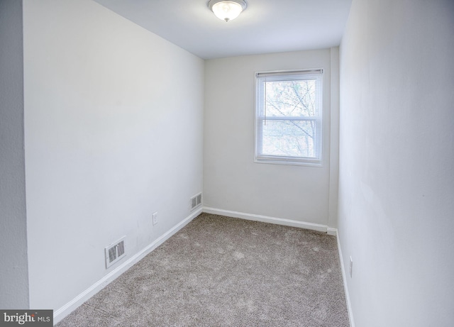 unfurnished room with light carpet