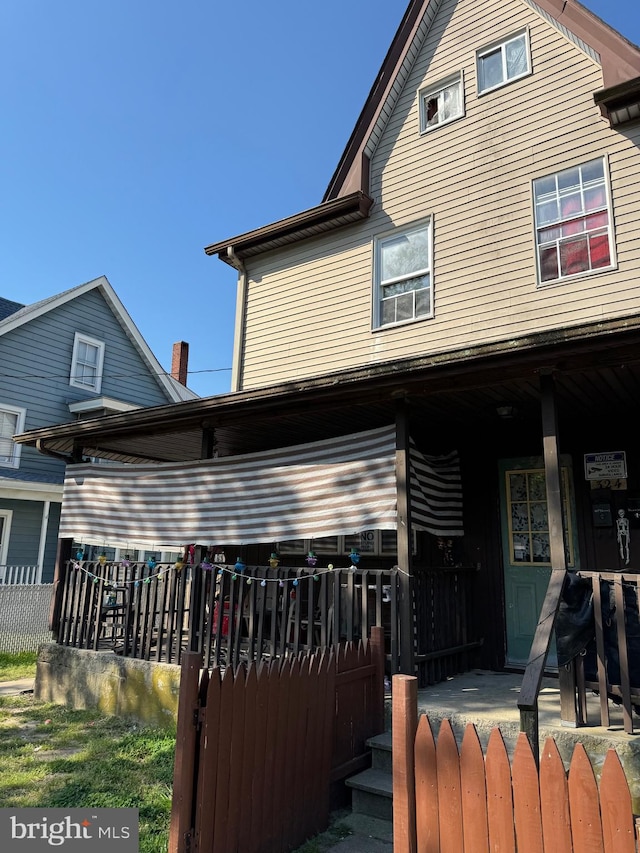 back of house featuring a porch