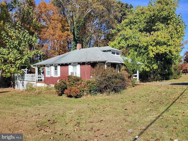 view of side of home featuring a lawn