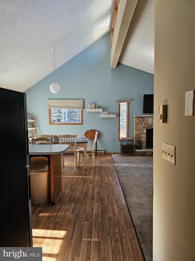 interior space featuring a textured ceiling, high vaulted ceiling, dark hardwood / wood-style floors, and beam ceiling