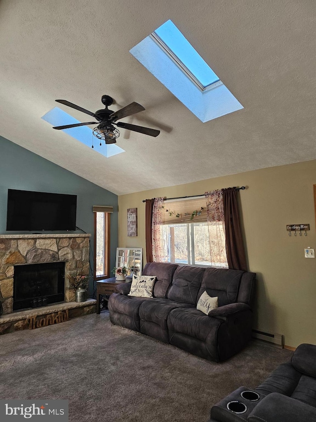 carpeted living room with a stone fireplace, a baseboard heating unit, a textured ceiling, and vaulted ceiling