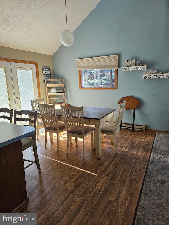 dining room with french doors, a textured ceiling, dark hardwood / wood-style flooring, a baseboard heating unit, and lofted ceiling