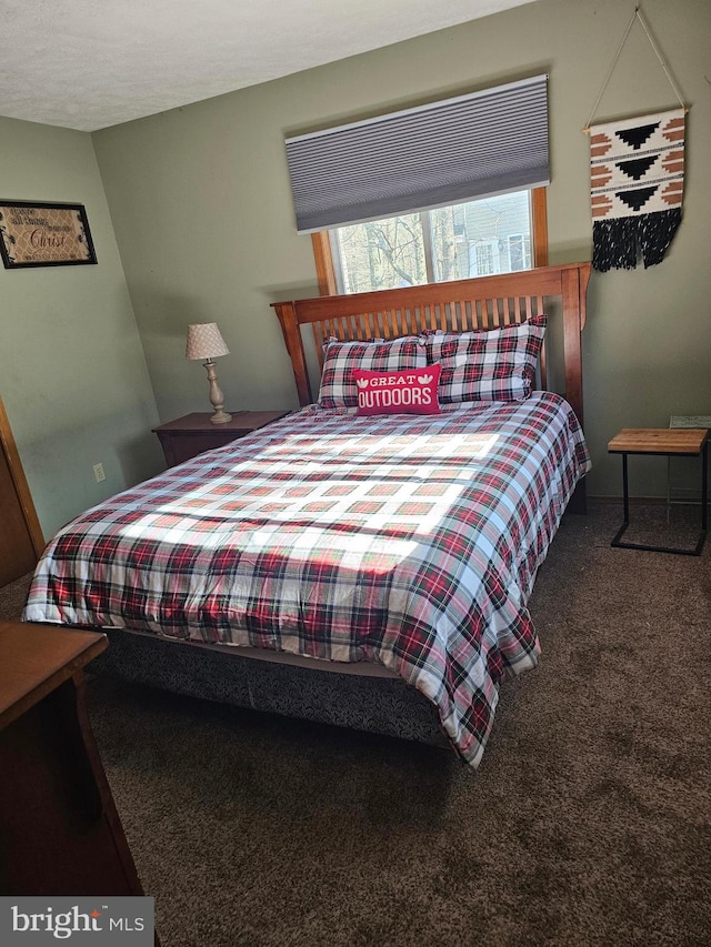 bedroom with carpet and a textured ceiling