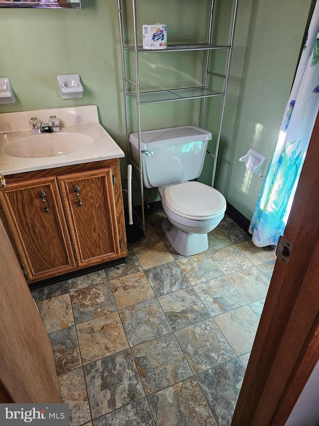 bathroom with toilet and vanity