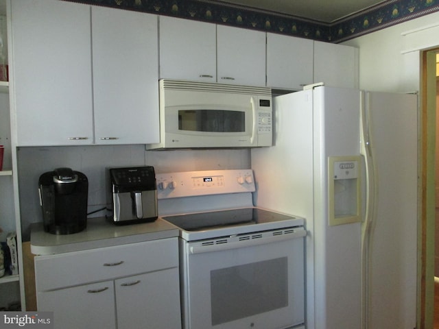 kitchen featuring white cabinetry, tasteful backsplash, and white appliances