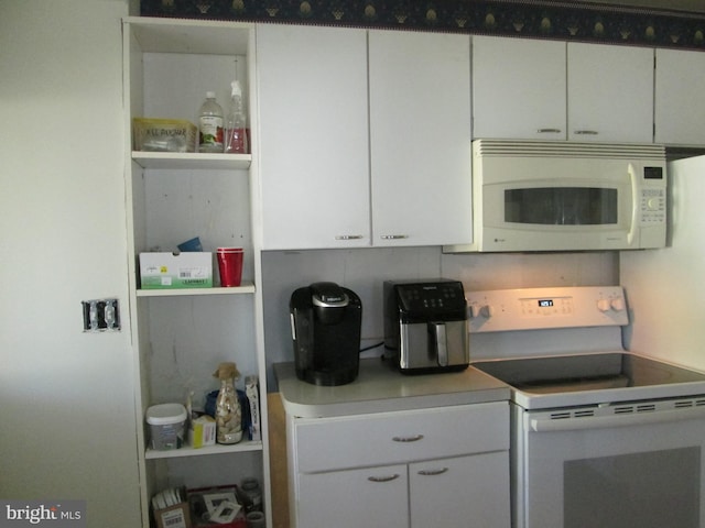 kitchen with white cabinets and white appliances