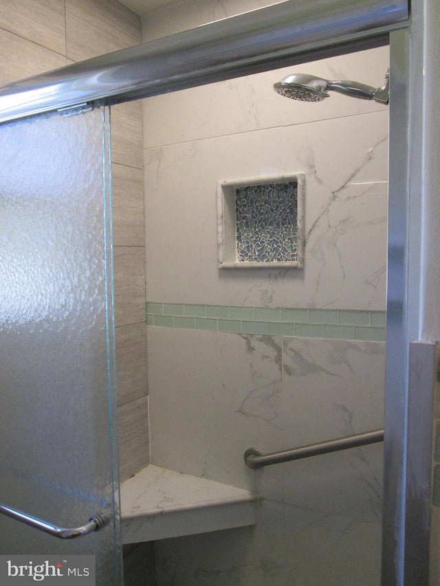 bathroom with a shower with shower door