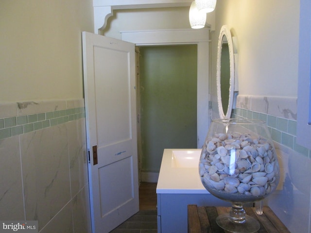 bathroom featuring tile walls and vanity