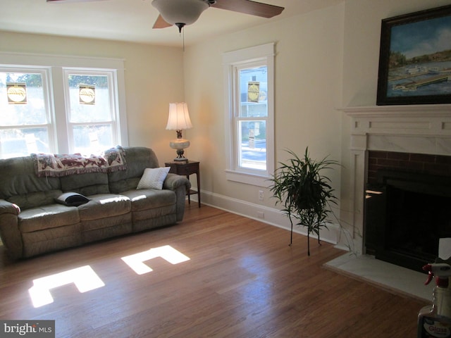 living room with ceiling fan, hardwood / wood-style flooring, and plenty of natural light