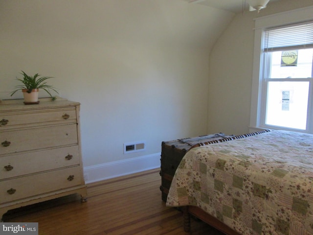 bedroom featuring wood-type flooring and lofted ceiling