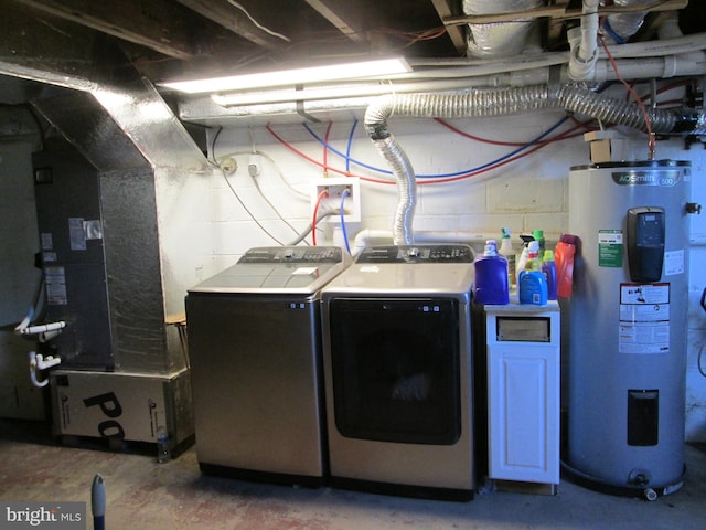 washroom with electric water heater and washing machine and dryer