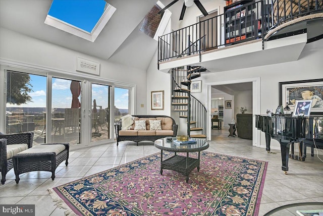 living room with a skylight, high vaulted ceiling, and light tile patterned floors