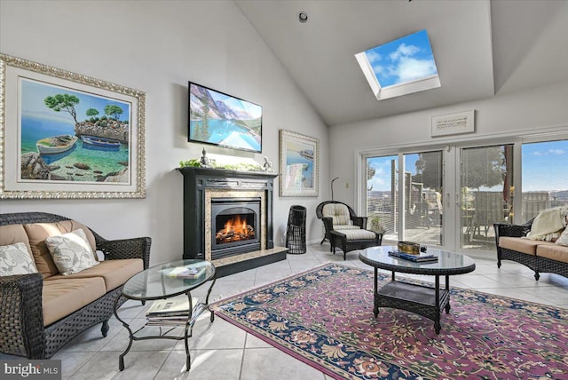 living room with light tile patterned floors, a skylight, and high vaulted ceiling