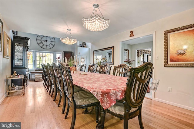 dining room with a notable chandelier and light hardwood / wood-style floors