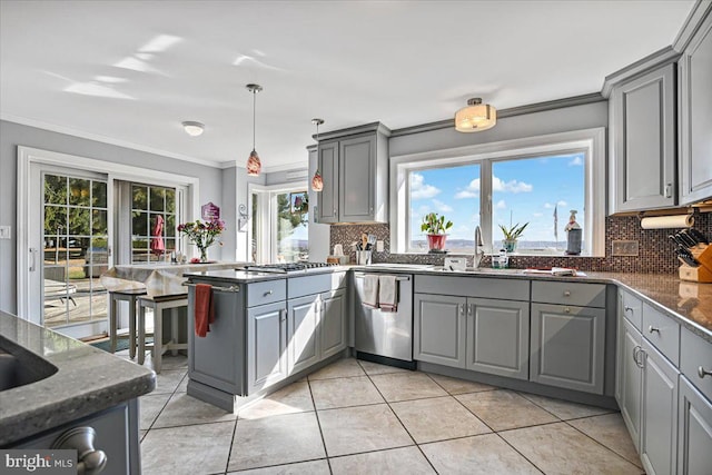 kitchen with appliances with stainless steel finishes, gray cabinets, and tasteful backsplash