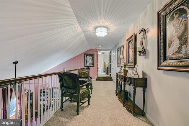 hall with light colored carpet and lofted ceiling