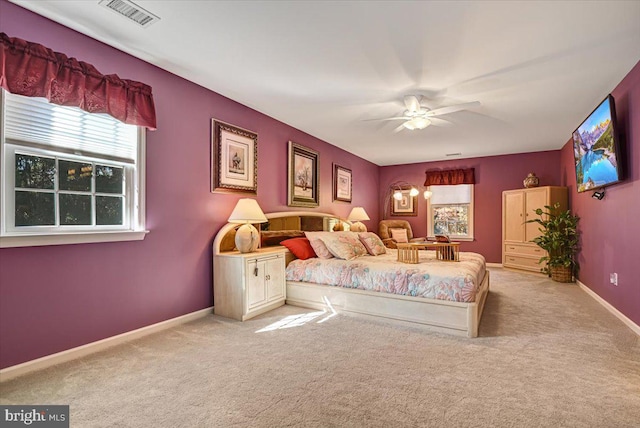 bedroom with ceiling fan and light colored carpet