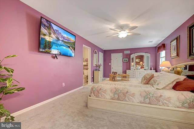 carpeted bedroom with ceiling fan and ensuite bathroom