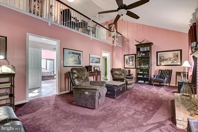 living room featuring carpet, ceiling fan, and a towering ceiling