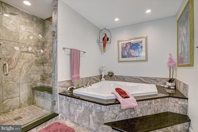 bathroom featuring separate shower and tub