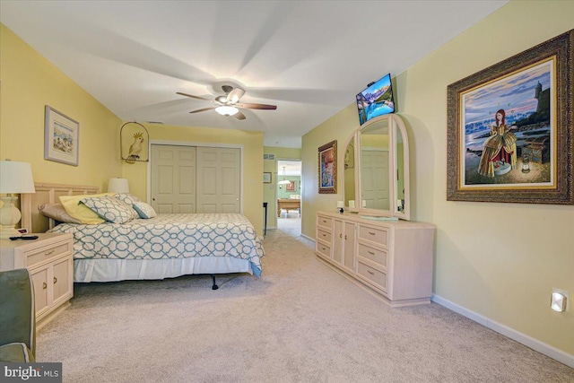 carpeted bedroom featuring a closet and ceiling fan