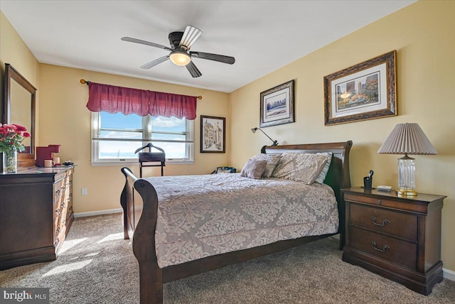 bedroom with ceiling fan and light colored carpet