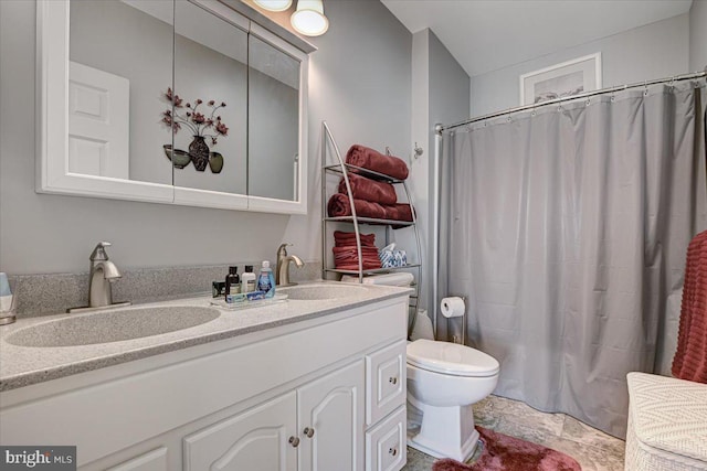 bathroom featuring walk in shower, vanity, and toilet