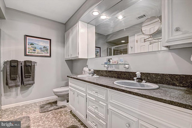 bathroom featuring tile patterned floors, vanity, an enclosed shower, and toilet