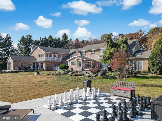 exterior space featuring a patio area and a front lawn