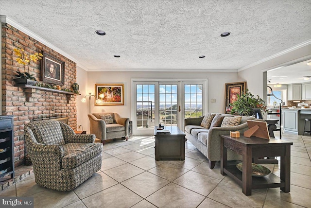 living room with ornamental molding, a textured ceiling, light tile patterned floors, and a brick fireplace