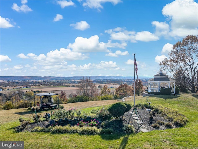 view of yard featuring a gazebo and a rural view