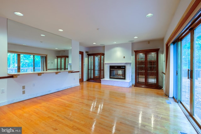 unfurnished living room with light hardwood / wood-style flooring