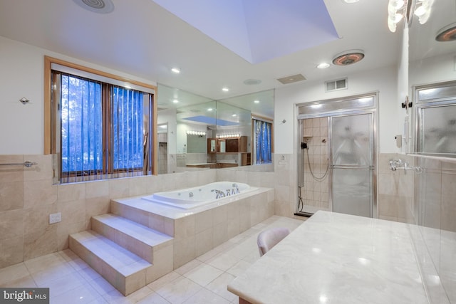 bathroom featuring plus walk in shower, tile patterned floors, and tile walls